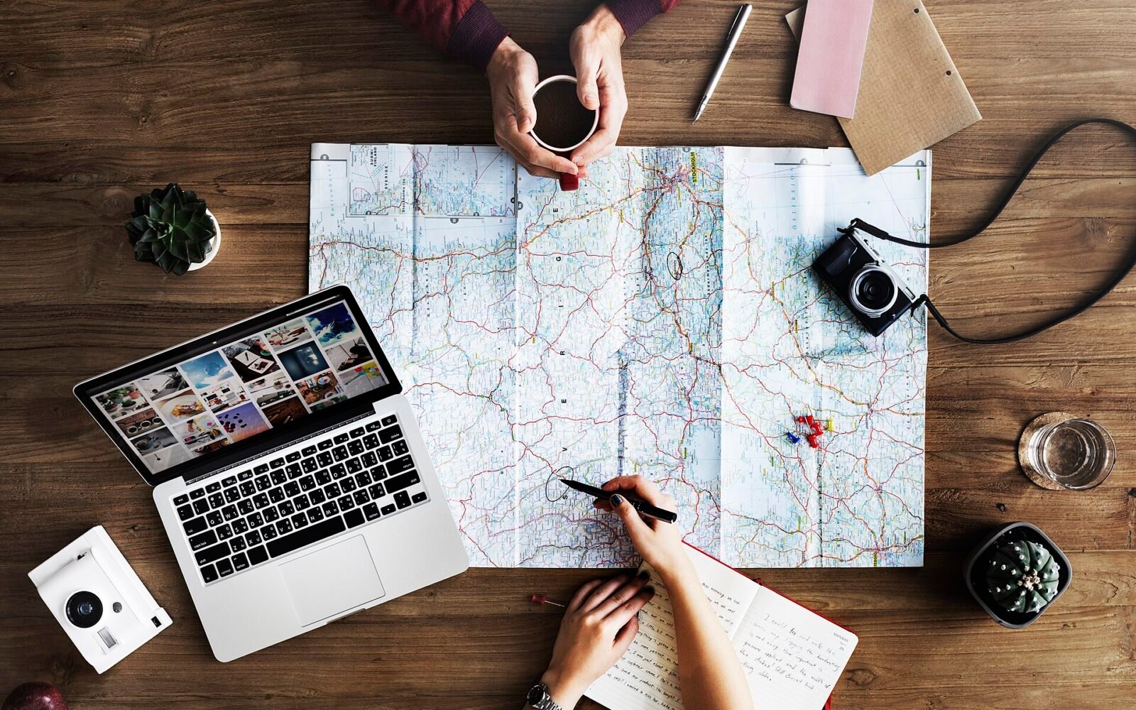 Trip planning with a map and laptop