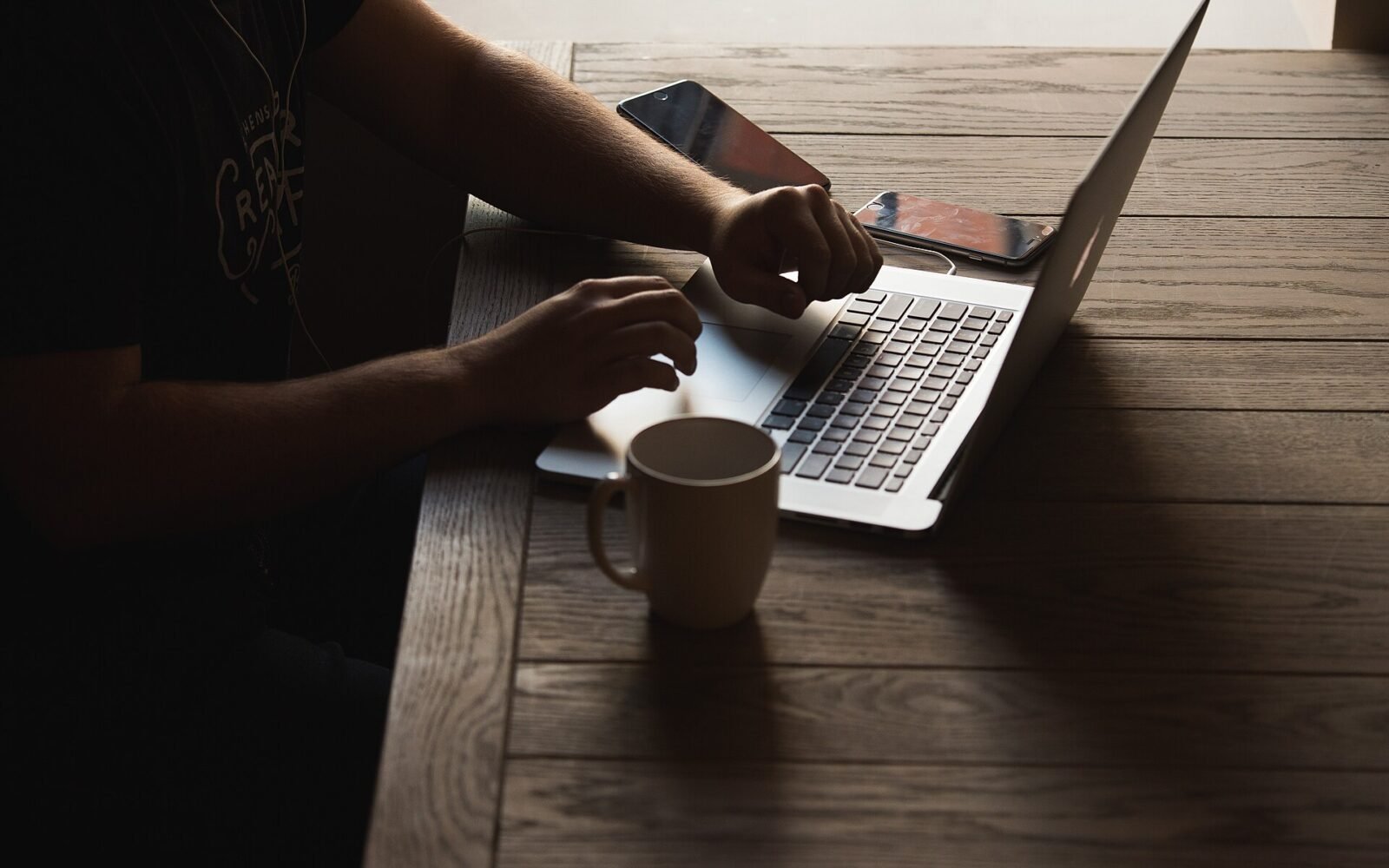 Developer working on a laptop with code visible